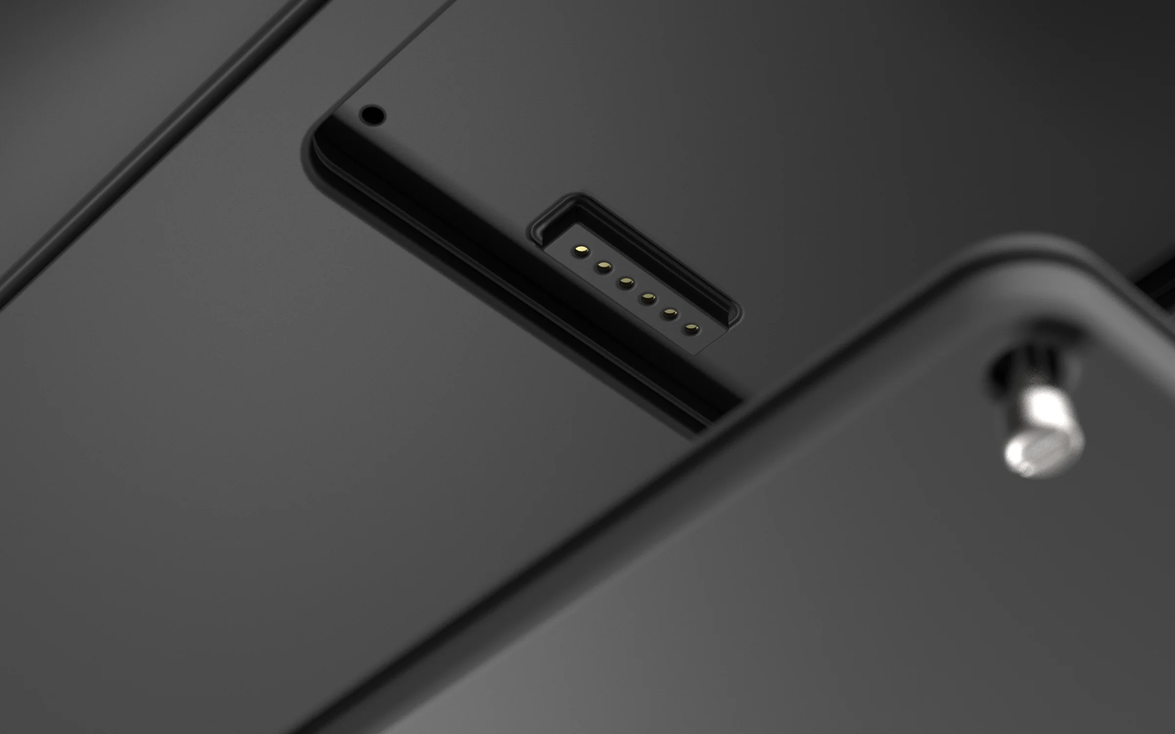 Close-up of the magnetic charging and data contact block recessed into the hull