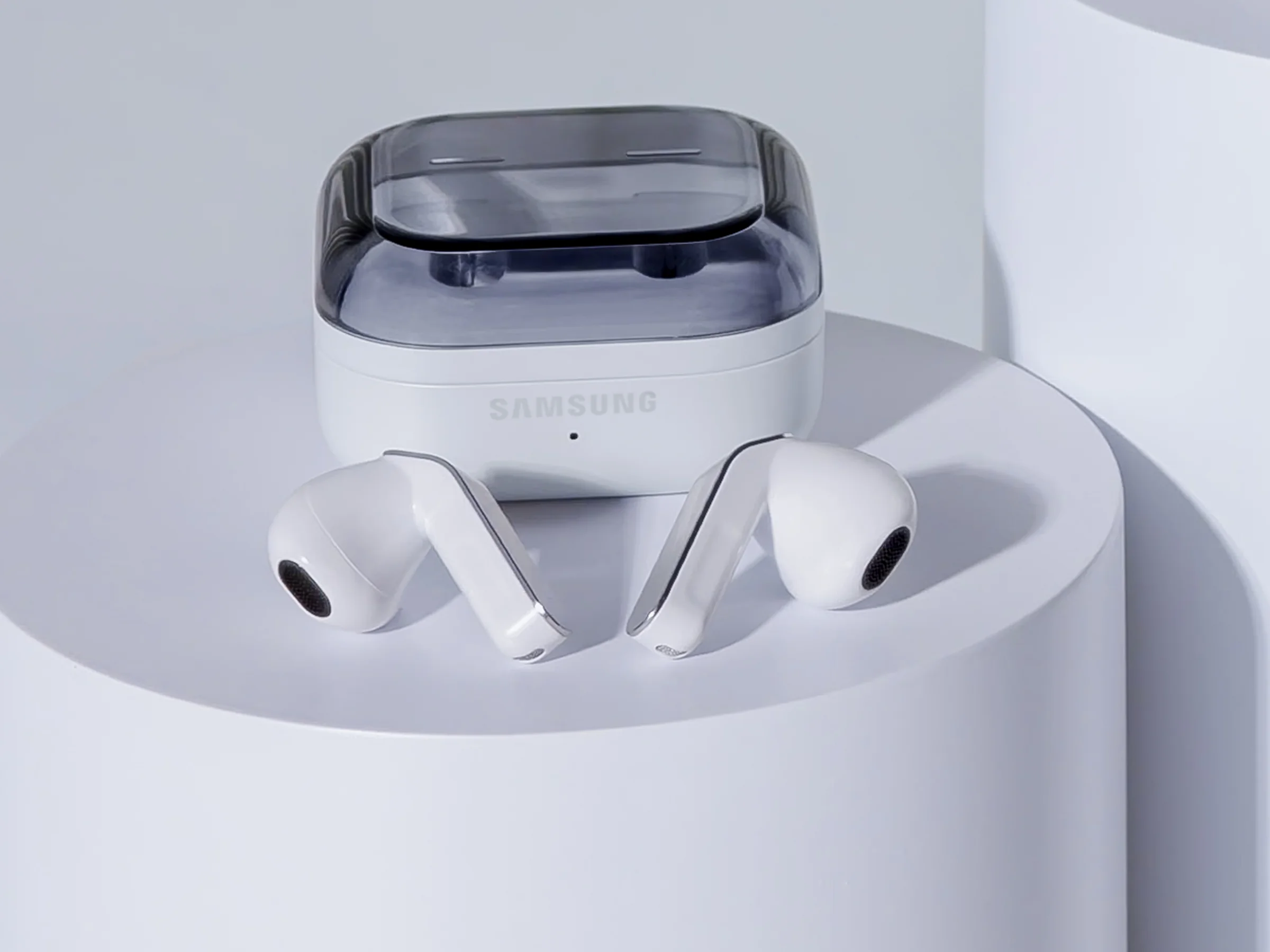 Samsung Galaxy Buds4 Pro press photo: two white stem-style earbuds in front of their open case